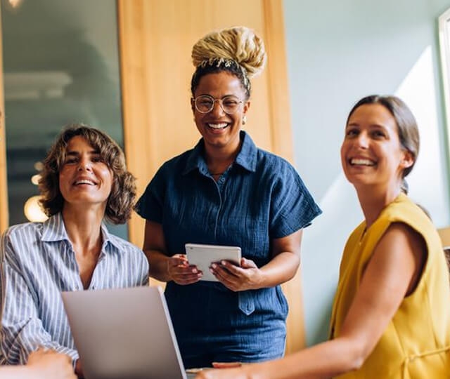 Três mulheres sorrindo no escritório Três mulheres sorrindo no escritório